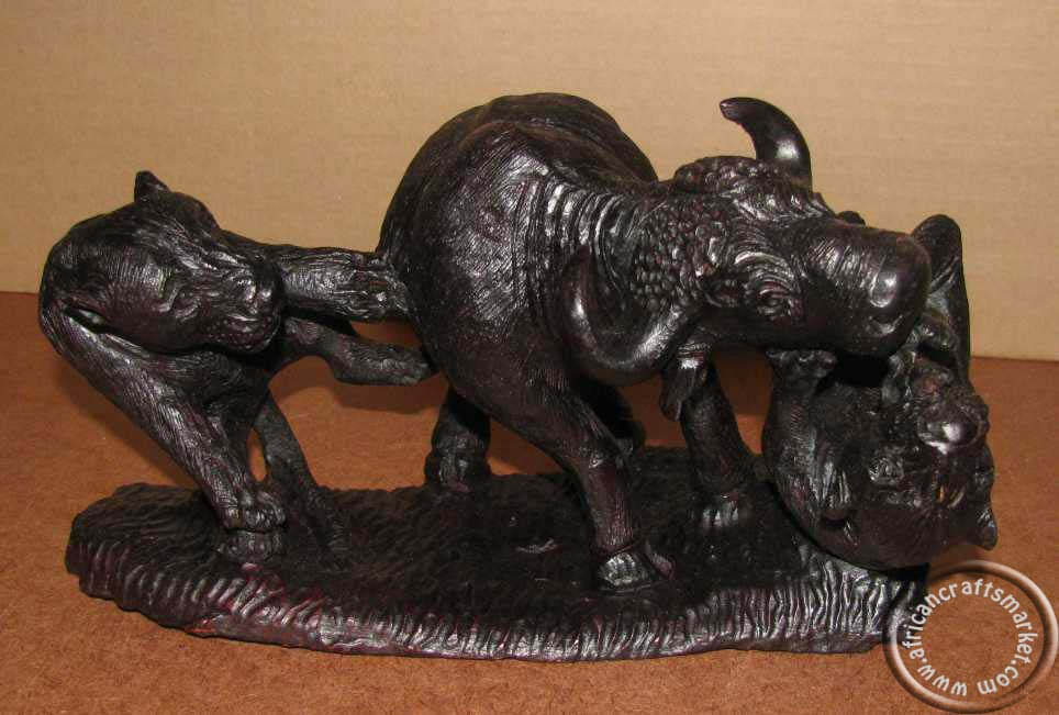 African lions attacking a buffalo - Iron wood carving