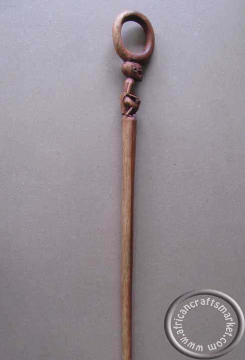 African sitting man cane