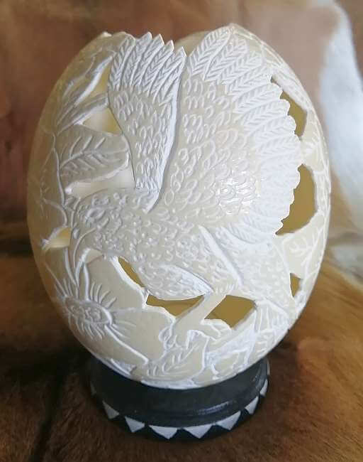Carved ostrich egg - Bird and candle
