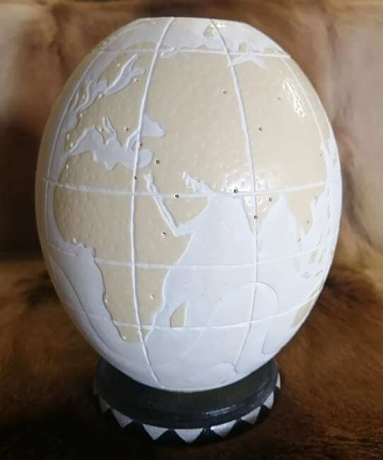 Carved ostrich egg - World map and candle