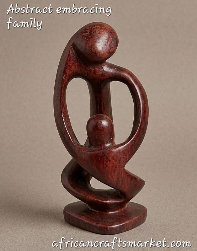 Abstract Shona stone sculpture of a mother and child embracing, featuring fluid minimalist lines and a highly polished dark finish