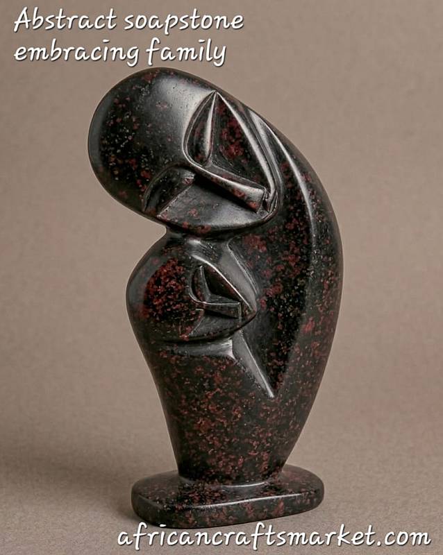 Abstract African soapstone family sculpture representing unity, featuring hand-carved minimalist figures intertwined in smooth polished stone.