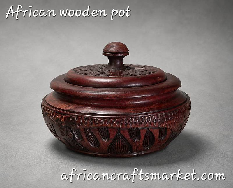 Traditional African wood storage bowl featuring hand-carved indigenous wildlife details and decorative tribal patterns.