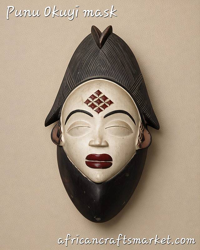 Hand crafted African wooden Punu mask with traditional white kaolin face paint