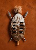 Miniature African Zulu hide shield measuring 10 cm, handcrafted tribal warrior curio for home display