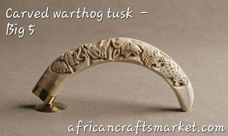 Carved Warthog Tusk - big 5 Masterfully hand-carved genuine warthog tusk sculpture featuring a seamless relief carving of the complete African Big 5 wildlife animals.
