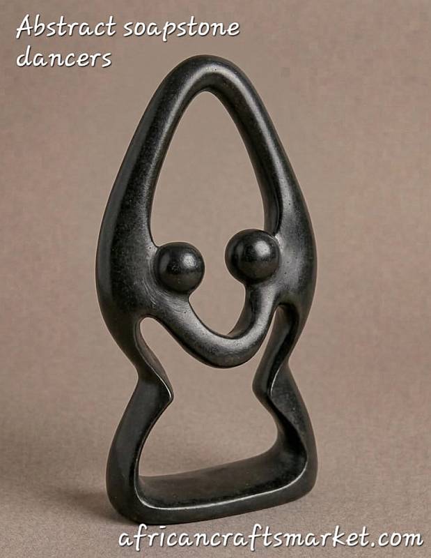Hand-carved African abstract soapstone sculpture of two dancers intertwined, showcasing smooth fluid curves and polished dark stone