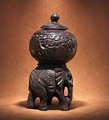 African Wood Elephant Storage Box - Handcrafted Carving Handcrafted traditional African wood elephant storage box with a hand-carved lid finial and rustic tribal details