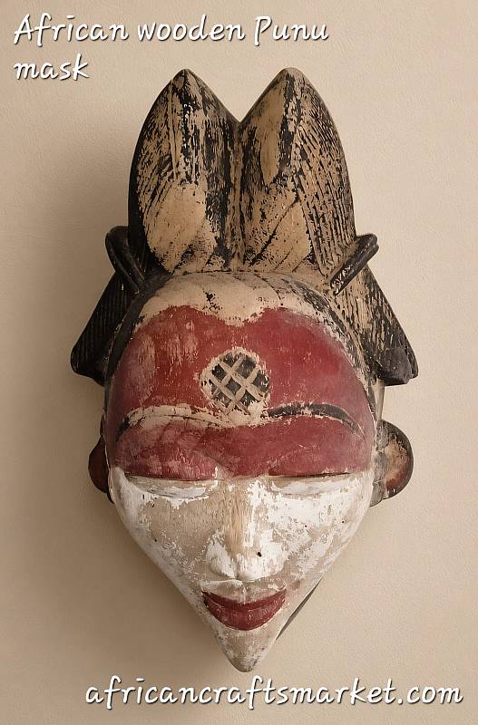 African Punu Mukudj Mask – Handcrafted Wall Art Authentic African Punu Mukudj wooden mask featuring intricate raised scarification patterns