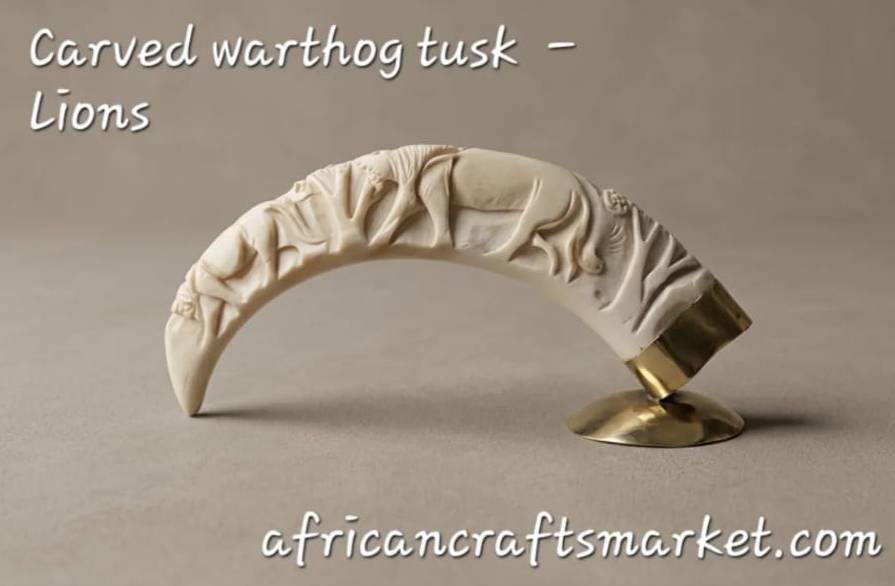 Carved Warthog Tusk - Lion Legally sourced genuine warthog tusk fine art piece showcasing traditional local hand-carving and a detailed wildlife lion scene.