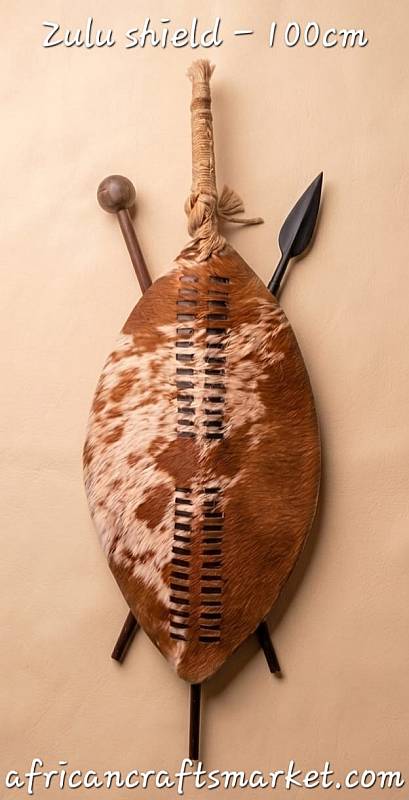 Authentic 1-Meter (100cm) Zulu Shield | South African Tribal Art A genuine 1-meter (100cm) traditional Zulu warrior shield showcasing natural unique cattle hide patterns